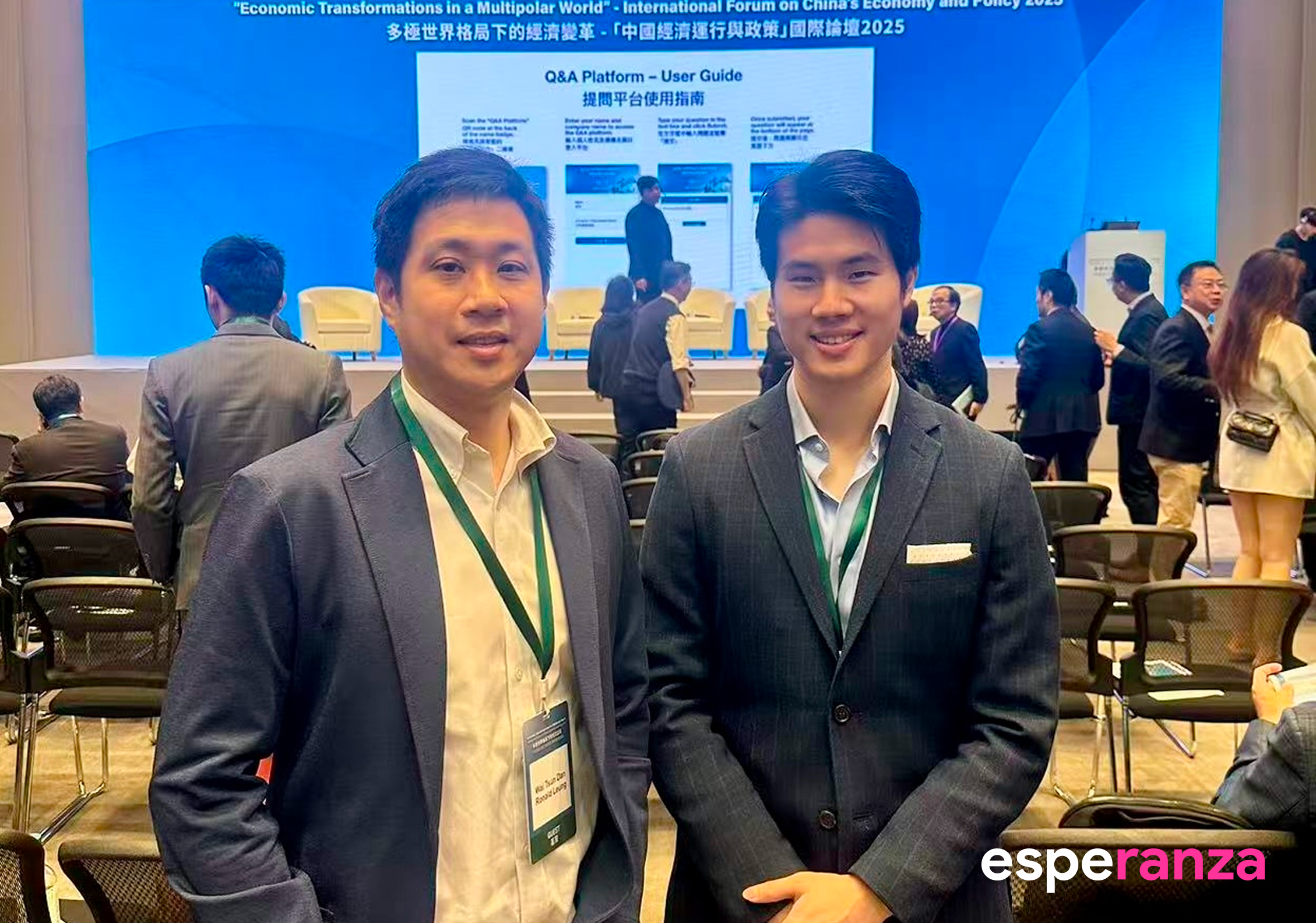 Two attendees at the China Economy and Policy Forum 2025, photographed in the conference venue