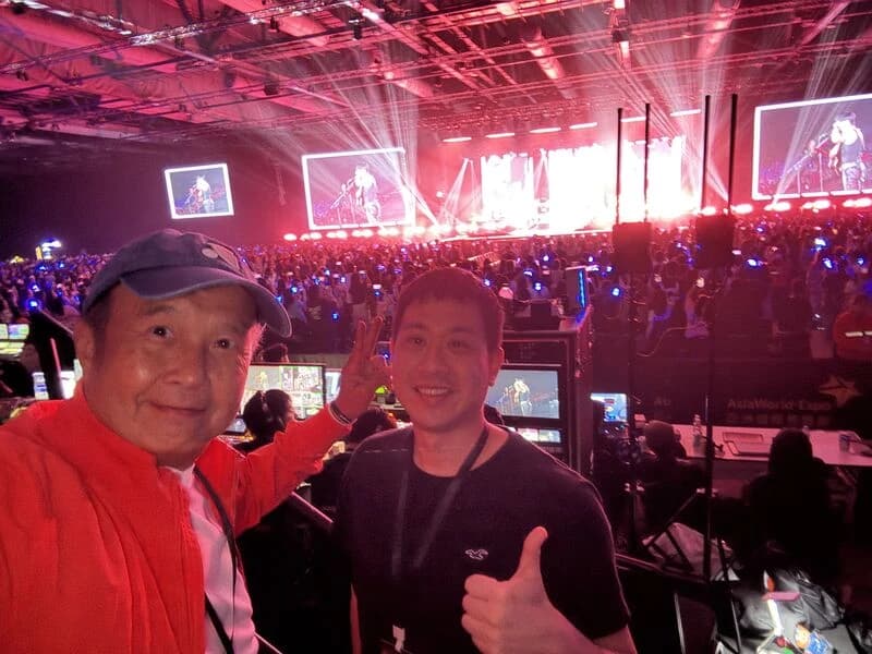 Concert attendees photographed with the stage behind them